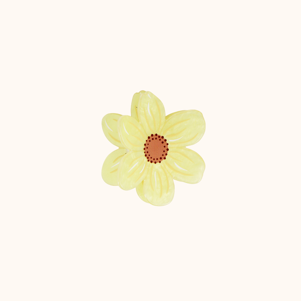 La pince fleur jaune avec coeur marron